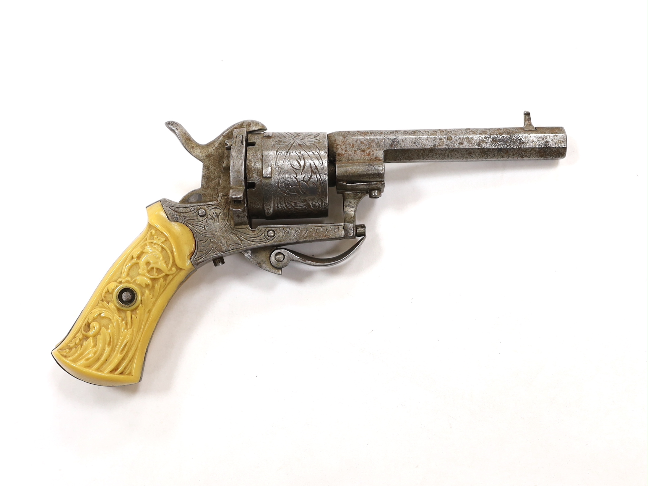 A six shot, 7mm Belgian self cocking pinfire revolver, octagonal barrel, roll engraved frame and cylinder fitted with two piece moulded casein grips